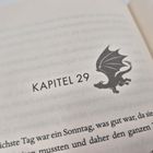 Text: "Kapitel 29". Daneben eine Illustration eines Drachens. Darunter beginnt der Text eines Buches.