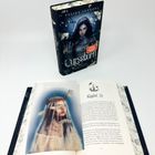 Text: "Kapitel 26" und "Curseborn". Cover zeigt eine Frau mit Kapuze. Geöffnetes Buch enthält eine Illustration einer Frau mit Krone aus Zweigen.