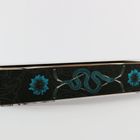 Längliche schwarze Schachtel mit blauen Blumen und einer blauen Schlange als Design.