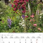 Kalender für Juli 2027. Üppiger Garten mit roten Rosen, lila und weißen Blüten, grünem Laub und im Hintergrund eine Laube.