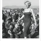 "Marilyn Monroe. Amerikanische Schauspielerin und platinblonde Ikone der Popkultur", lächelnd inmitten von Soldaten.