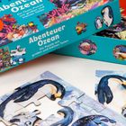 "Abenteuer Ozean. Ein Team-Puzzle mit großen und kleinen Teilen." Bunte Puzzleverpackung mit Pinguin-Motiv.