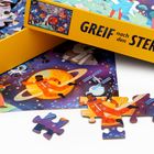 Die Verpackung zeigt "GREIF nach den STERNEN!" in gelb. Eine Illustration mit Astronauten im Weltraum und Cartoon-Charakteren.