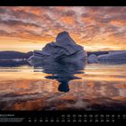 "Eisberg-City in Grönland", August-Kalenderseite. Eisberg spiegelt sich im Wasser unter einem farbenfrohen Sonnenuntergang.