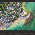 Kalenderblatt mit Datum 8. Ansicht von oben auf ein Dorf am Meer mit Booten und grün-blauem Wasser.