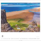 Strand Rauðisandur, Vestfirðir. Felsvorsprung über grüner Landschaft, weitem Sandstrand und blauem Meer. August-Kalenderseite.