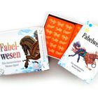 "Fabelwesen: Ein fantastisches Memo-Spiel" auf Schachteln. Bunte Fabelwesen-Illustrationen und Kartenmotive innen.