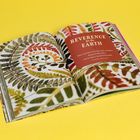 Text: "Reverence for the Earth." Zitat von Nancy Phillips. Offenes Buch mit bunten Blättermustern auf gelbem Hintergrund.