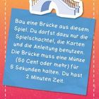 Der Text fordert, eine Brücke aus Spielmaterial zu bauen, die eine Münze 5 Sekunden halten kann. Zeitlimit: 2 Minuten.