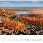 Herbstlandschaft. Kalenderseite "9". Steine und bunte Herbstbäume vor einem weiten, von Wasser durchzogenen Tal.