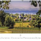Text: "Uhldingen" und Kalenderdaten, darunter Landschaft mit Kirche, Wiesen und Hügeln, See und Bergen im Hintergrund.