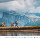 Kalenderblatt September mit Radfahrern vor einer großen Bergkulisse, Spiegelung im Wasser darunter.