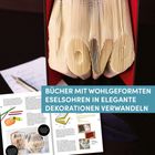 BÜCHER MIT WOHLGEFORMTEN ESELSOHREN IN ELEGANTE DEKORATIONEN VERWANDELN. Buchseiten formen das Wort "LOVE".