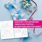 "Geeignet für Anfänger:innen und fortgeschrittene Bastler:innen." Zwei blaue Papierfische und Muscheln auf blauem Hintergrund.