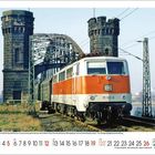 Oberhalb: "111 141-6 mit E1810 durch den ... Zustand 1987"  
Unten: Kalendertage mit Hervorhebung am 9. und 26.  
Zug auf Brücke mit zwei Türmen, im Hintergrund Landschaft.