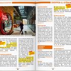 **Texte:**  
- „You’re Beautiful“  
- „Altes Eisen“ meint hier die ehemalige Metallfabrik Norblina – nicht ihre Kundschaft  
- Wasser, bunt und laut  
- Im Sommer gibt’s abends vor dem Gebäude Brunnen-Lichtshows mit Musik  

**Beschreibung:**  
Ein modernes Einkaufszentrum, detailreicher Innenraum mit industriellem Design. Ein Fußgänger führt einen Hund an der Leine.