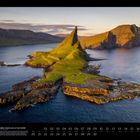 "09 INSELBERG TINDHÓLMUR AUF DEN FÄRÖER. Küstenlandschaft mit grünem Inselberg, umgeben von Wasser."