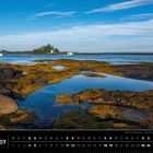 "Kanada 09", darunter ein Kalender für September. Küstenszene mit Wasser, Felsen, Algen und zwei Booten im Hintergrund.
