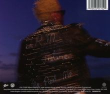 Ein unscharfer Mann mit gelbem Haar und Sonnenbrille vor blauem Himmel, Barcode oben rechts.