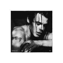 Der Text "DON'T FORGET TO LIVE" ist auf einem Arm tätowiert. Ein nachdenklich wirkendes Schwarz-Weiß-Porträt.