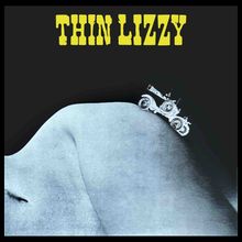 "THIN LIZZY" in gelber Schrift, ein altes Auto fährt über eine Hügelkontur, die wie ein Körper aussieht.