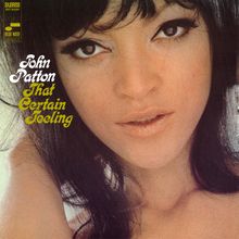 Text: "John Patton That Certain Feeling." Nahaufnahme eines Frauengesichts, dunkles Haar, ausdrucksstarke Augen.