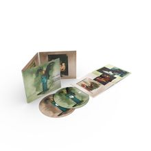 Texte: "TORI AMOS," "IN TIMES OF DRAGONS." CD-Packung mit zwei Discs und einem Booklet, stilisiertes Frauenbild.