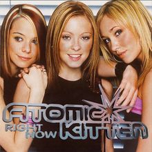 „Atomic Kitten Right Now“. Drei lächelnde Frauen posieren eng beieinander, sie haben blonde bis braune Haare.