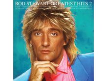 "ROD STEWART GREATEST HITS 2". Blondhaariger Mann mit blauem Sakko, Hand am Kinn, vor türkisfarbenem Hintergrund.