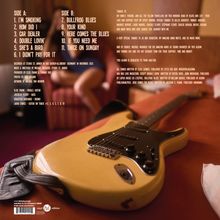 Seite A enthält Titel wie "I’m Smoking" und "How Did I", während Seite B Songs wie "Bullfrog Blues" bietet. Eine Gitarre liegt im Vordergrund.