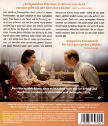 „Zeitgemäßes Märchen, in dem es um den Sinn des Lebens geht.“ Paar sitzt am Tisch, unterhält sich bei Wein.