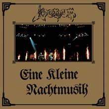 Text: "Venom" oben, "Eine Kleine Nachtmusik" unten. Bild zeigt eine Bühne mit Lichtern und Flammen. Rahmen verziert.