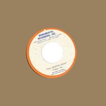 "MONUMENTAL RECORDING, INC.", "COLD HEARTED WOMAN", Tommy Uhr. Ein Schallplatten-Etikett auf einem braunen Hintergrund.