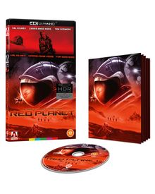 "4K ULTRA HD", "RED PLANET", "Val Kilmer", "Carrie-Anne Moss", "Tom Sizemore". Rotes Marsmotiv mit Astronautenhelm.