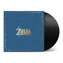 "THE LEGEND OF ZELDA BREATH OF THE WILD" in Gold auf blauem Hintergrund. Links die Box, rechts mehrere schwarze Vinyl-Schallplatten.