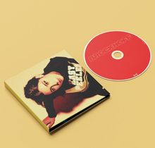 CD mit roter Schrift "BROCKHOFF", daneben eine Hülle mit einem Foto einer Person in gelbem Licht.