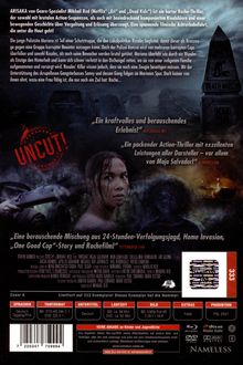 "UNCUT!" steht in großen roten Buchstaben. Eine Frau mit nassen Haaren schaut über ihre Schulter. Hinter ihr ist ein dunkler, mysteriöser Hintergrund mit einer Statue und einem brennenden Fahrzeug zu sehen.