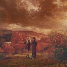 Es gibt keinen sichtbaren Text. Zwei Personen stehen in einer herbstlichen, roten Landschaft unter dramatischen Wolken.