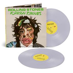 Texte: "ROLLING STONES", "FOREIGN TONGUES". Illustration eines karikaturhaften Gesichts mit verzerrten Zügen.