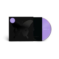"DEATH CULT PARADISE LIVE" auf lila Sticker. Schwarzer Hintergrund mit Schmetterlingsmotiv. CD daneben, hell-lila.