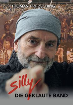 Thomas Fritzsching, Silly Die Geklaute Band. Älterer Mann mit Mütze zeigt auf den Betrachter, Konzert im Hintergrund.