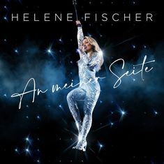 Text: "HELENE FISCHER" und "An meiner Seite". Frau in glitzerndem Outfit schwebt im Dunkeln mit leuchtenden Sternen.