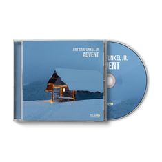 CD-Cover von Art Garfunkel Jr. mit dem Titel "Advent". Eine verschneite Holzhütte mit Lichtern vor winterlicher Landschaft.