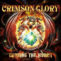 „Crimson Glory“, „Chasing the Hydra“. Fantasievolle Drachen umrahmen einen leuchtenden Edelstein.