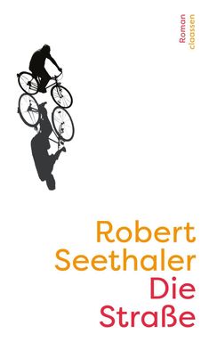 "Robert Seethaler Die Straße" in gelbe und blaue Schrift, unscharfe Straßenszene mit schemenhaften Personen im Hintergrund.