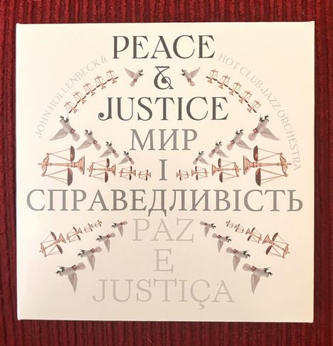 Texte: Peace & Justice, Мир і справедливість, Paz e Justiça. Darstellung von Tauben und Waagen als Symbole.