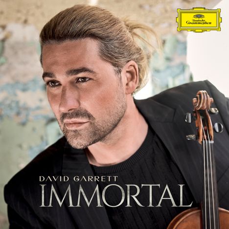 „DAVID GARRETT IMMORTAL“; Mann mit Violine, blonder Dutt, nachdenklich; gelbes Logo oben rechts.