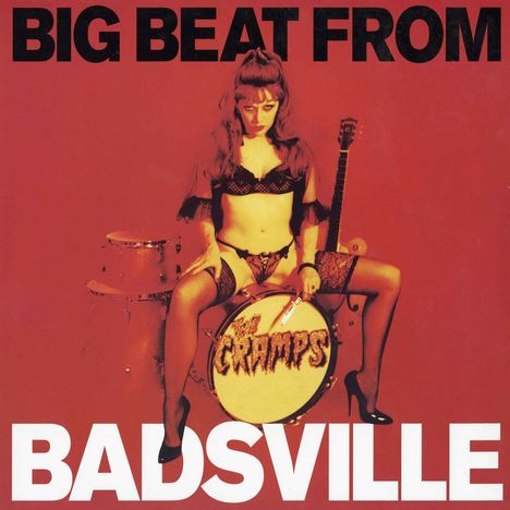 Text: "BIG BEAT FROM BADSVILLE". Illustration: Frau in lacker Kleidung auf einer Trommel mit Gitarren im Hintergrund.