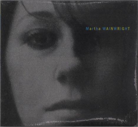 Text: "Martha Wainwright". Nahaufnahme eines Gesichts in Schwarz-Weiß, starker Schatteneffekt.