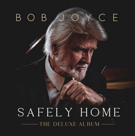 Text: "BOB JOYCE", "SAFELY HOME", "THE DELUXE ALBUM". Ein älterer Mann mit grauem Haar in nachdenklicher Pose.